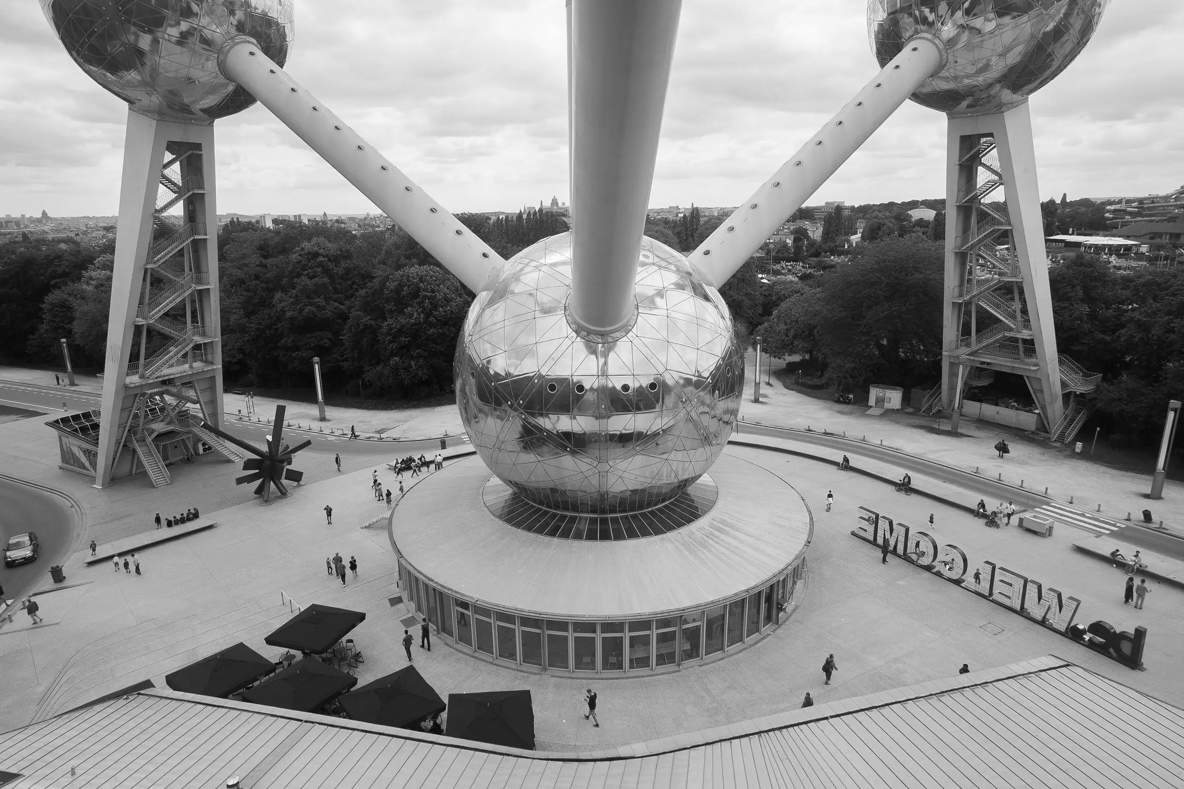 High-angle black-and-white photo of the Atomium spheres above a paved plaza.